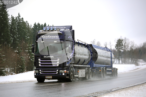 Image of Purple Scania R500 Tank Truck on Rainy Day