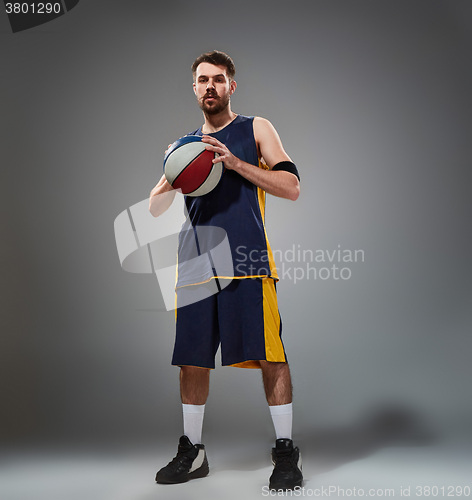 Image of Full length portrait of a basketball player posing with ball 