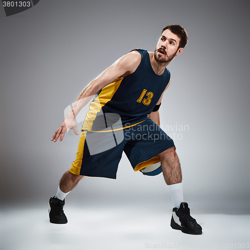 Image of Full length portrait of a basketball player with ball 