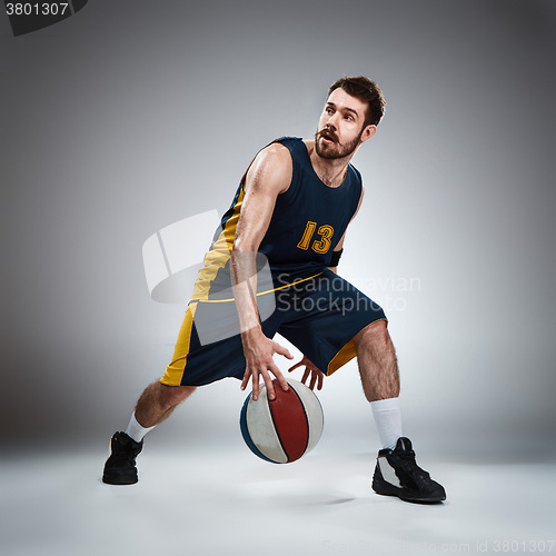 Image of Full length portrait of a basketball player with ball 