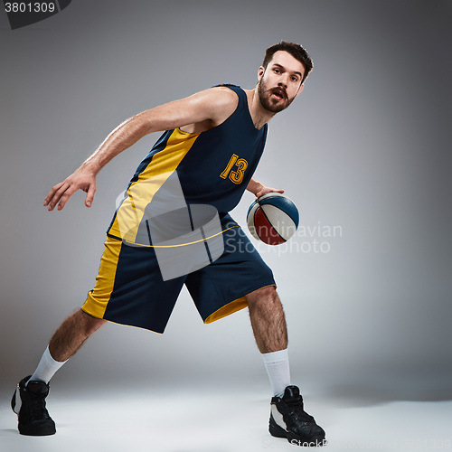 Image of Full length portrait of a basketball player with ball 