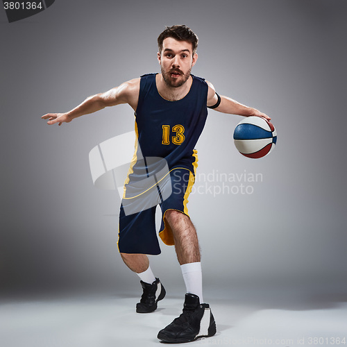 Image of Full length portrait of a basketball player with ball 