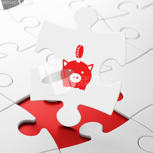 Image of Money concept: Money Box With Coin on puzzle background
