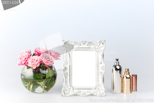 Image of Flowers vase and vintage frame on white