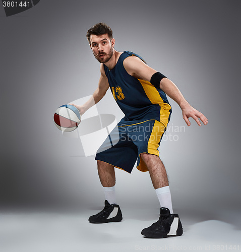 Image of Full length portrait of a basketball player with ball 