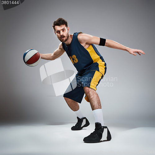 Image of Full length portrait of a basketball player with ball 