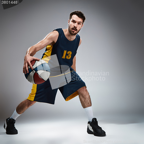 Image of Full length portrait of a basketball player with ball 