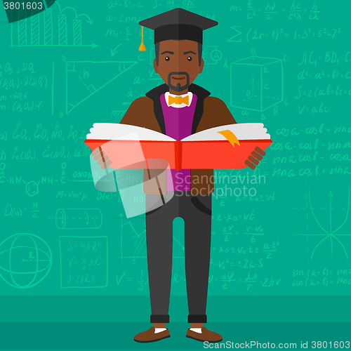 Image of Man in graduation cap holding book.