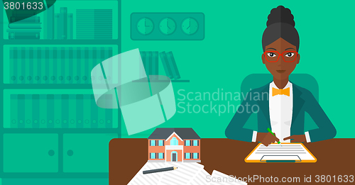 Image of Real estate agent signing contract.