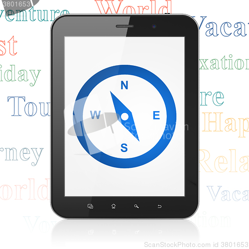 Image of Vacation concept: Tablet Computer with Compass on display