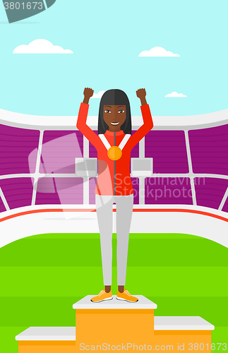 Image of Athlete with medal and hands raised.