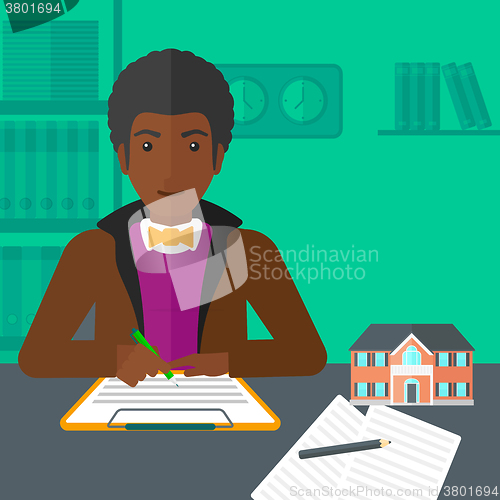 Image of Real estate agent signing contract.