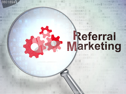 Image of Marketing concept: Gears and Referral Marketing with optical glass