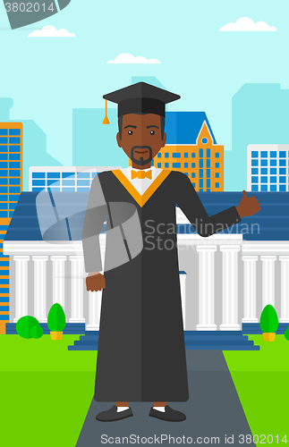 Image of Graduate showing thumb up sign.