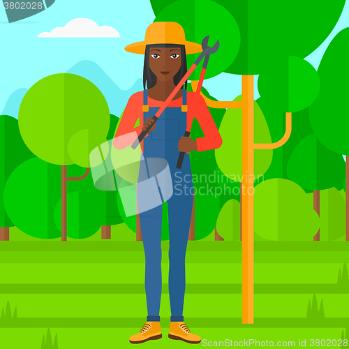 Image of Farmer with pruner in garden.