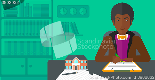 Image of Real estate agent signing contract.