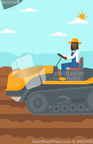 Image of Farmer driving catepillar tractor.