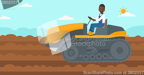 Image of Farmer driving catepillar tractor.