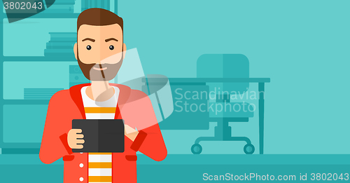 Image of Man using tablet computer.