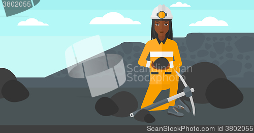 Image of Miner holding coal in hands.