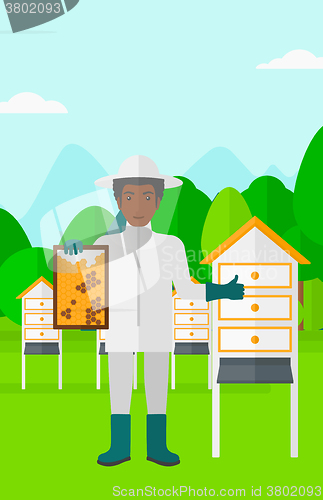 Image of Bee-keeper at apiary.