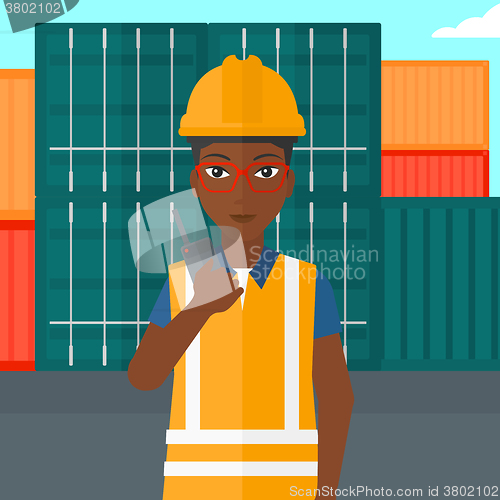 Image of Stevedore standing on cargo containers background.