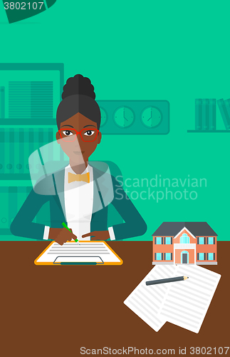 Image of Real estate agent signing contract.