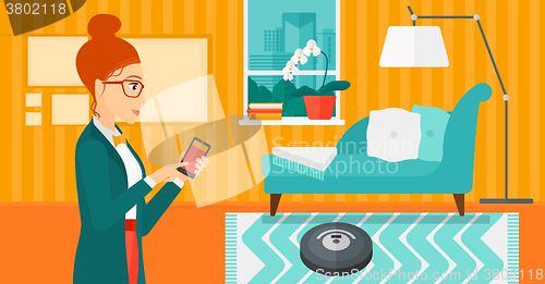 Image of Woman with robot vacuum cleaner.