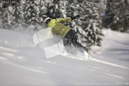 Image of snowboarder woman enjoy freeride on fresh powder snow