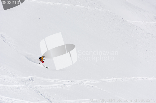 Image of freeride skier skiing in deep powder snow