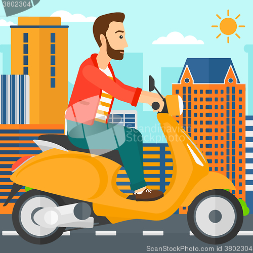 Image of Man riding scooter.