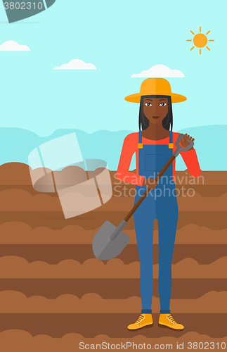 Image of Farmer on the field with shovel.