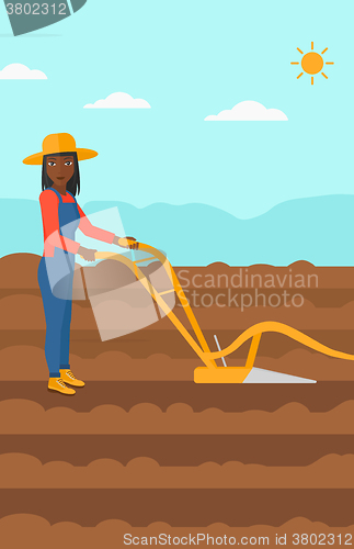 Image of Farmer on the field with plough.