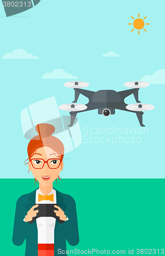 Image of Woman flying drone.