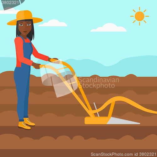 Image of Farmer on the field with plough.