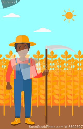 Image of Farmer on the field with scythe.