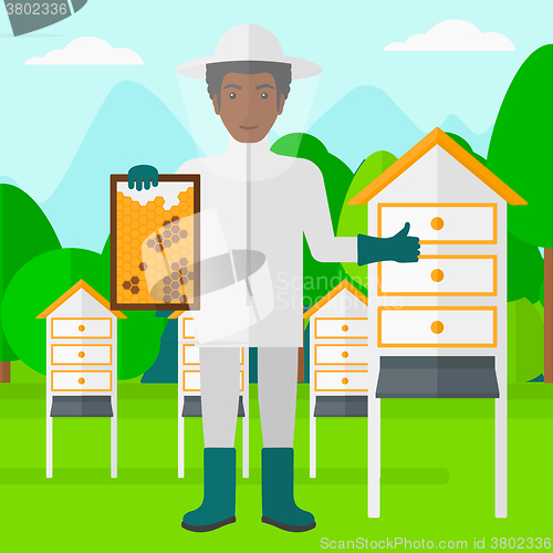 Image of Bee-keeper at apiary.