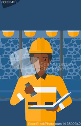 Image of Miner checking documents.