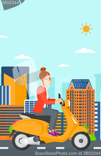 Image of Woman riding scooter.