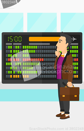 Image of Man looking at schedule board.