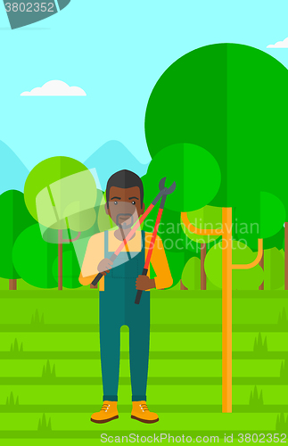 Image of Farmer with pruner in garden.