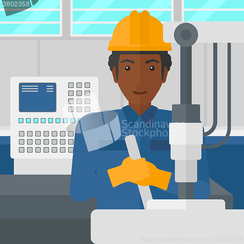 Image of Man working with industrial equipment.