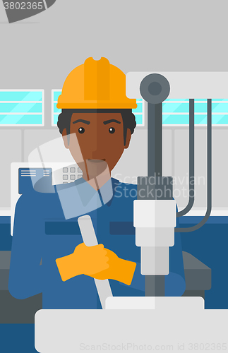 Image of Man working with industrial equipment.