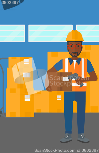 Image of Worker checking barcode on box.