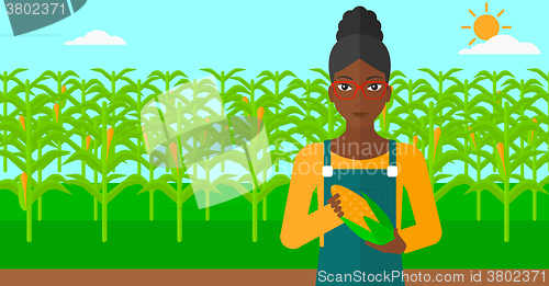 Image of Farmer holding corn.