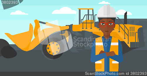 Image of Miner with mining equipment on background.