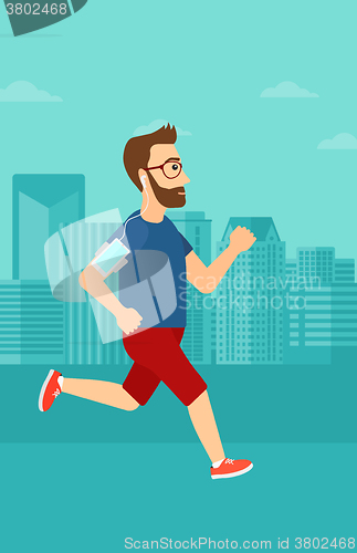 Image of Man jogging with earphones and smartphone.