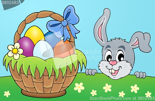 Image of Decorative egg basket and lurking bunny