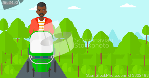 Image of Man pushing pram.