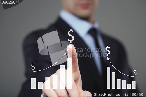 Image of Businessman Touching a Graph Indicating Growth. dollar sign 